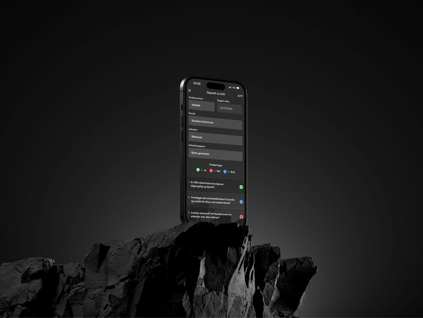 Stående iPhone oppå svarte steiner.